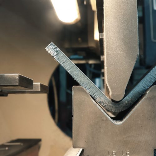The process of metal bending on a CNC bending machine. Bending of metal using a v-shaped matrix and a punch. The process of metal bending on a CNC bending machine. Bending of metal using a v-shaped matrix and a punch.